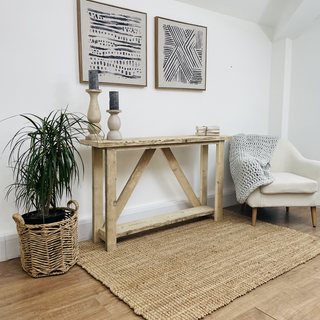 Discover the artisanal charm of the Ryde Console Table, meticulously crafted from reclaimed wood. This stylish piece boasts a storage shelf, blending rustic allure with eco-friendly design.