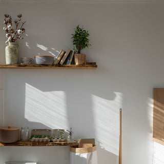 Set of three wall-mounted floating shelves featuring rustic design. Versatile storage solution for bathroom, kitchen, and living room decor.
