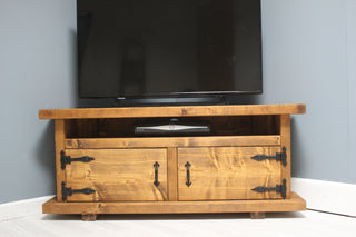 Discover the rustic charm of the Hale TV unit, perfect for your entertainment space. Crafted from solid wood, this corner cabinet offers ample storage and style.