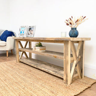 Experience the rustic charm of our Winford shoe rack table, handmade in the New Forest from reclaimed and distressed wood. Crafted from solid, recycled wood, this versatile piece functions as both an end table and a shoe storage cabinet.