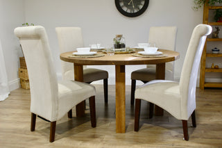 This round kitchen table exudes farmhouse charm with a modern twist, making it an ideal choice for both cottage and modern decor. Crafted as a bespoke dining table, it can be customized by length, width, style, color, and finish, ensuring it perfectly complements your space.