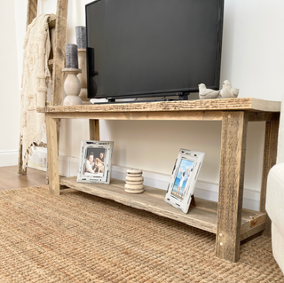 The Ryde TV unit, a rustic console stand crafted from reclaimed wood. This television stand exudes farmhouse charm, featuring salvaged wood for a natural, weathered look. Perfect for adding rustic flair to your home.