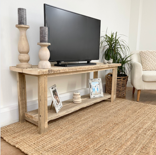 Transform your living room with the Ryde TV unit, a rustic console stand crafted from reclaimed wood. This television stand, perfect for larger audio equipment, features salvaged wood for a natural and distressed look.
