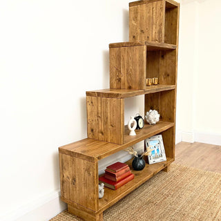 The Ashurst Reclaimed Bookcase is a versatile furniture piece designed for under stair shelves or as a stylish addition to any room. Crafted from reclaimed and solid wood, this rustic bookcase offers modern shelving solution.