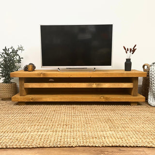 Elevate your living room with the Ashlett TV unit, a handmade rustic entertainment console crafted from solid wood. This bespoke piece features rustic charmperfect for adding warmth and character to your home.