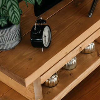 The Canada TV unit brings rustic charm to your living room. Crafted from solid wood, it includes a storage shelf for media devices.