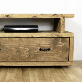Rustic wooden TV unit with spacious drawer for cable storage, handmade from solid wood.