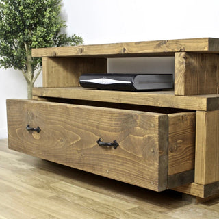 Explore rustic elegance with the Highwood TV unit, featuring a large draw for storage. Crafted from solid wood, this rustic TV unit adds charm to any living space.