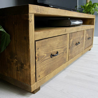 The Highwood TV unit offers generous storage in a rustic design, combining functionality with rustic charm.