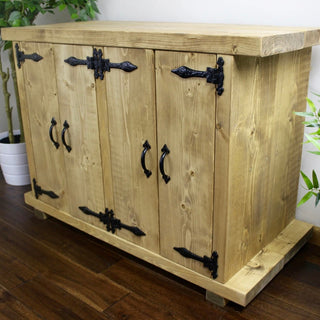 Elevate your aquatic display with the handmade Blashford fish tank stand, a rustic solid wood piece featuring storage cabinets for both style and functionality.