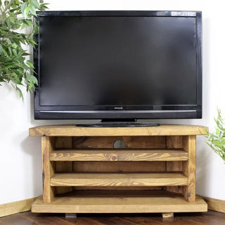 Enhance your TV area with the rustic Holbury corner TV unit, featuring shelves for media storage. Customisable and solid wood for bespoke fit.