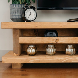 The Canada TV unit is a rustic wooden entertainment piece for your living room. Crafted from solid wood, it offers storage and style.