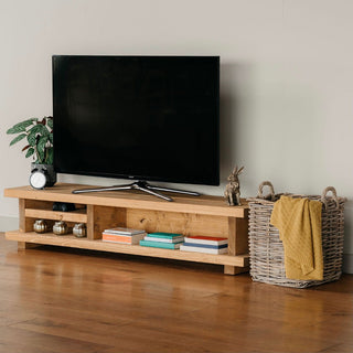 Enhance your living room with the Canada TV unit, a rustic and solid wood entertainment piece. Featuring a storage shelf, it adds versatility and style.