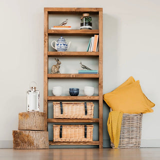 Add rustic charm to your space with the Highcliffe Solid Wood Tall Bookcase Shelving Unit. Handcrafted from solid wood for enduring quality and style.