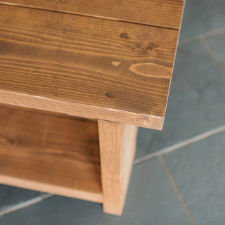 Introduce rustic charm with the Colbury Handmade Coffee Table. Crafted from solid wood, featuring a storage shelf for added convenience.