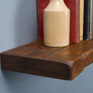 Explore the timeless appeal of the Handmade Wall Mounted Shobley Floating Shelf. Crafted from rustic solid wood, this space-saving and versatile storage solution seamlessly blends into your decor, offering a stylish and functional addition to your home.