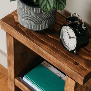 Add rustic elegance to your space with the Hinton small side table, crafted from solid wood for a timeless addition to your living room or bedroom.