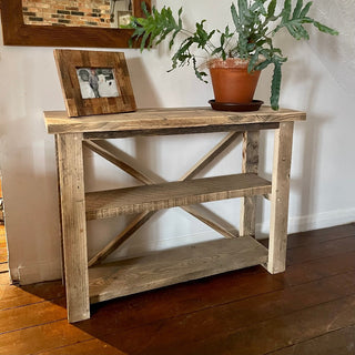 Enhance your living space with the Winford shelving unit, featuring shelves for storage and a rustic cross design. Whether in the living room, dining room, bedroom, or hallway, it offers both functionality and style, perfect for displaying books and decor items while embodying the natural beauty of wood.
