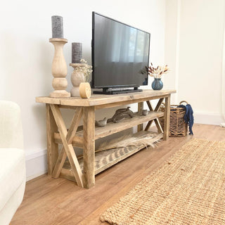 Introducing the Winford Solid Wood Reclaimed TV Unit with Storage: Handmade in Hampshire, this bespoke piece combines rustic elegance with modern functionality, featuring a unique cross design and ample storage for your audio equipment.