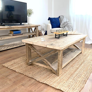 Step into rustic elegance with the Winford Reclaimed Solid Wood Coffee Table, a stylish centerpiece boasting both charm and practicality with its integrated storage shelf.