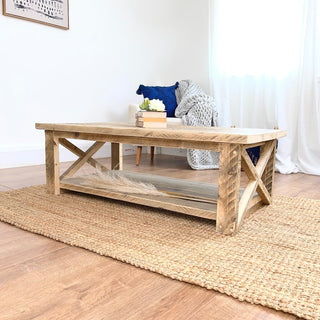 Discover the rustic elegance of the Winford Reclaimed Solid Wood Coffee Table, a sustainable centerpiece that combines style and functionality with its storage shelf.