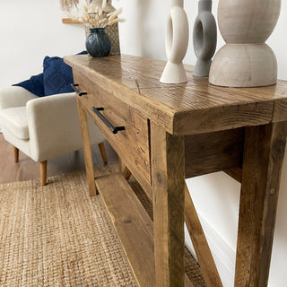 The Barton Console Unit, delivered fully assembled, seamlessly blends functionality and style. Crafted from chunky solid wood with a reclaimed design, it adds warmth and character to any home decor, whether modern, farmhouse, or traditional