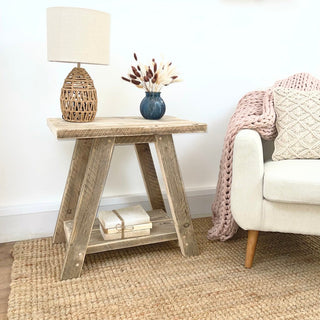 Yarmouth side table, a rustic reclaimed furniture piece crafted from salvaged and distressed wood. This cottage-inspired wooden table adds warmth and character to any room, featuring storage for added functionality.