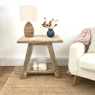 Introduce rustic charm to your living space with the Yarmouth side table, crafted from reclaimed and distressed wood. This cottage-inspired reclaimed side table adds warmth and character to any room. Featuring an open shelf design, it's perfect as a bedside table or side table.
