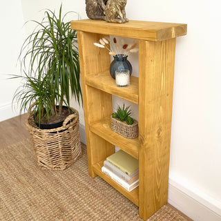 Meet your storage needs with the Winsor Solid Wood Narrow Rustic Bookshelf, a tall and narrow shelving unit designed for both style and functionality.