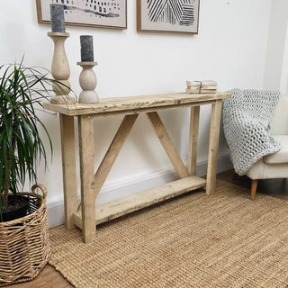 Introducing the Ryde console table: A meticulously handcrafted piece from reclaimed wood, boasting a storage shelf for added functionality.