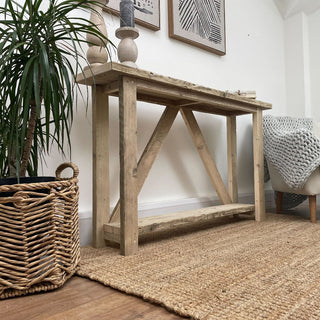 Introducing the Ryde Console Table: A meticulously crafted piece fashioned from reclaimed wood, boasting a storage shelf for practicality and rustic allure.