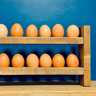 Solid wood egg holder finished in a medium stain, in a chunky rustic style, 2 tiers, each holding 6 eggs. Handcrafted in the New Forest.