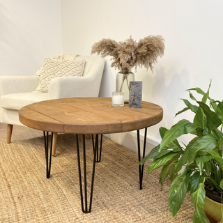 Explore the Hampton Handmade Rustic Round Industrial Coffee Table featuring metal hairpin legs for a blend of modern and rustic charm.