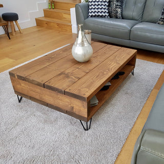 Elevate your living space with the Frogham Rustic Industrial Coffee Table. Solid wood craftsmanship, storage underneath, and industrial metal feet for a stylish touch.