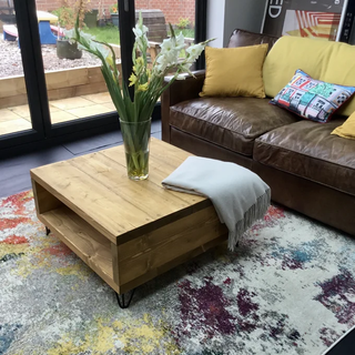 Elevate your living space with the Frogham Rustic Industrial Coffee Table. Solid wood construction with metal feet and convenient storage underneath.