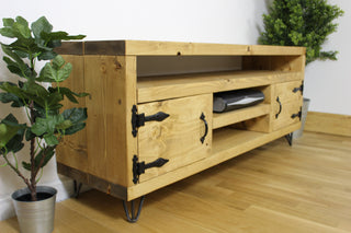 Enhance your entertainment space with the rustic charm of the Brook TV unit. Crafted from solid wood, it features harpin legs, a sound bar shelf, and two storage compartments for organized elegance. Ideal for your TV stand or media cabinet.