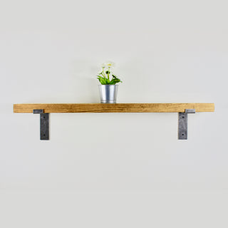 Transform your space with the rustic elegance of the handmade Blackshaw shelf, crafted from solid wood and accentuated by industrial brackets.