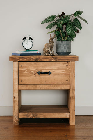 Add rustic charm to your bedroom with the Unit Breamore Handmade Rustic Solid Wood Bedside Table featuring a convenient drawer for storage.