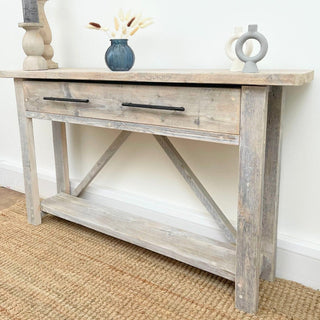 Enhance your hallway with the Barton Console Unit, equipped with a functional drawer for extra storage. Crafted from chunky solid wood with a rustic design.