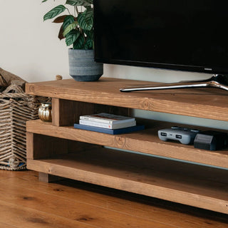 The Hartington TV unit is a rustic wooden entertainment unit, perfect for your living room. Crafted from solid wood, this console unit features a shelf for storage.