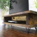 Solid wood TV unit, featuring industrial metal feet, finished in a chunky rustic style. Handcrafted in the New Forest.