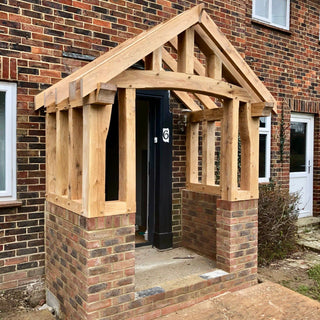 Solid Oak Orchid Porch Kit: Crafted from green oak with mortice and tenon joints, hand-cut rafters, and half lap joints. Comes pre-drilled with pegs and finished with linseed oil for natural grain enhancement.