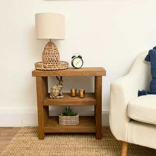 Experience the charm of the Bartley Side Table, a handcrafted and fully assembled masterpiece from the UK. With its rustic design crafted from chunky solid wood, this versatile end table adds a touch of modern elegance to your home. 