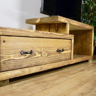 Lowick Solid Wood Rustic Handmade TV Unit: Crafted from sturdy wood, this rustic TV stand features a convenient drawer for storage, adding handmade charm to your living space.