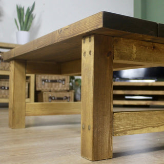 Enhance your farmhouse-inspired decor with the Rustic Sopley Coffee Table: A custom-designed centerpiece crafted from solid wood, perfect for adding rustic charm to your living space.