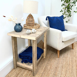 a rustic wooden accent perfect for farmhouse or cottage interiors. Crafted from solid wood, this charming side table adds a touch of modern farmhouse elegance to any room. With its natural wood finish, it brings warmth and character to your living room decor.