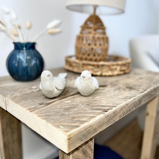 Experience rustic elegance with the Ryde side table, crafted from solid wood and perfect for farmhouse-inspired living rooms. This handcrafted piece features recycled and distressed wood, adding character to any space. The close-up view showcases the natural beauty of the wood grain, making it an ideal addition to your living room decor