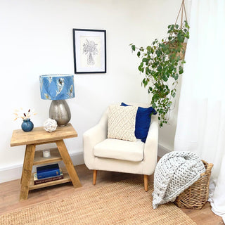 Enhance your living room with the rustic charm of our reclaimed Yarmouth side table, featuring a convenient shelf for storage. Crafted from solid, recycled wood, this small accent table embodies the natural beauty of distressed wood, perfect for cottage or farmhouse decor.