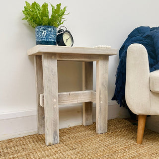 Photograph of the Ryde Reclaimed Solid Wood Small Side Stool, showcasing its artisanal craftsmanship. The stool is made from reclaimed wood, offering a rustic charm and functional elegance for versatile use in various spaces.