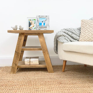 Featuring a shelf for convenient storage. Crafted from solid, recycled wood, this small accent table adds warmth to any living room. With its distressed and natural wood finish, it embodies the beauty of reclaimed wood, making it an ideal end table or accent piece for cottage or farmhouse decor.